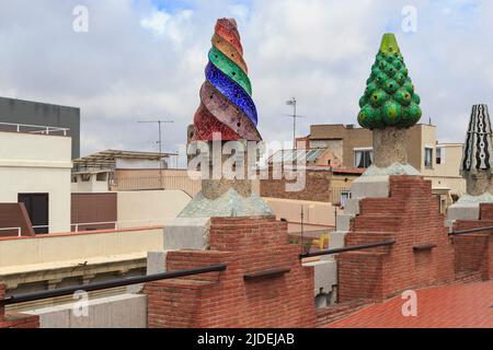 BARCELONA, SPAIN - MAY 10, 2017: These are colorful, ceramic-tiled chimneys of Gaudi's work on the roof of Guell's house. Stock Photo