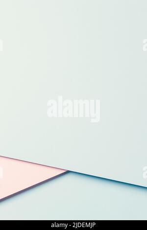 Abstract colored paper texture background. Minimal vertical composition with geometric shapes and lines in pastel pink and light green colors. Top Stock Photo