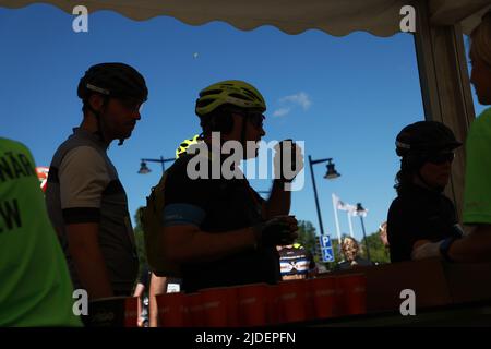 Cyclists and officials , in Askersund, during the world’s largest recreational bike ride, Vätternrundan, Sweden, on Friday. Vätternrundan is one of the world's largest exercise races by bicycle and this year 16,000 cyclists have registered to cycle the 315 km long race around lake Vättern. Stock Photo