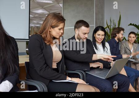 Business team using notebook computer while working on their project presentation Stock Photo