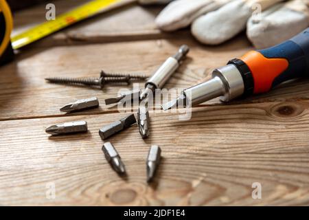 Screw drive. Adjustable torque screwdriver, work tool on wooden background. Hand tool on workshop table, closeup view Stock Photo