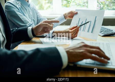businessman teamwork and brainstorming. people analyzing and discussing business financial report in office Stock Photo