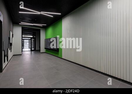 Corridor hall interior, with front door and elevator in many apartment building, with mailboxes with green walls Stock Photo