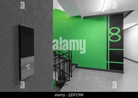Elevator call button in the hallway entrance to an apartment building Stock Photo
