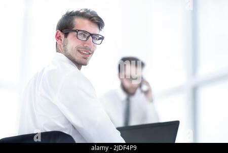 rear view.employees sitting at the office Desk Stock Photo