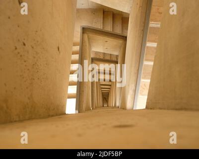 Top Down View of Stairs. Emergency Exit Concept. The winding stairs are empty. Abstract beige background. Stock Photo