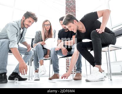 Business man passing over documents to leader during meeting Stock Photo