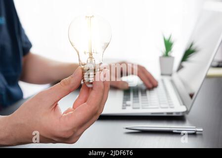 Business, creative idea concept. Businessman holding light bulb Stock Photo