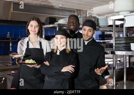 Team of restaurant staff in kitchen Stock Photo