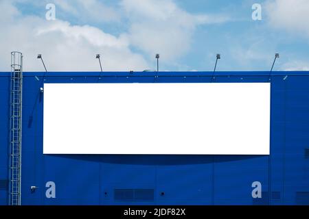 Mock up template. Big horizontal white blank signboard, advertising billboard on modern building wall outdoors Stock Photo