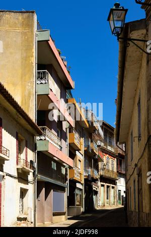 Narrow cobbled street between townhouses in Mirandela, Portugal Stock Photo