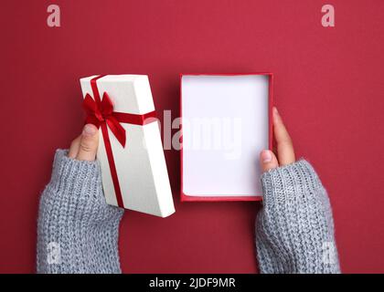 Hands holding gift box opened.Empty holiday paper box product advertisement display.Christmas present.Valentine's day  surprise.New year design contai Stock Photo