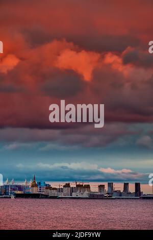 Magic pink sky over the residential complex under construction on the embankment of the Neva River on Vasilievsky island in sunset, bulk island Stock Photo