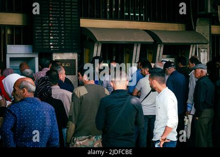 Damascus, Syria - May, 2022: Queue of people in front of Commercial Bank of Syria in Damascus Stock Photo