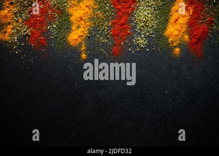 Spices powder on black slate background top view. Stock Photo