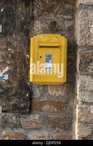 Yellow post box on a road in the French Pyrenees Stock Photo
