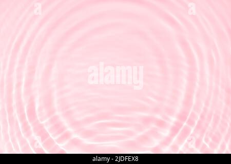 Pure swimming pool water background toned pastel pink color with sun ray lights on it. Sun reflections on water drops circles. Trendy summer banner Stock Photo