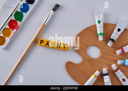 Top view painting tools on white background. Watercolor palette and paintbrush. Stock Photo