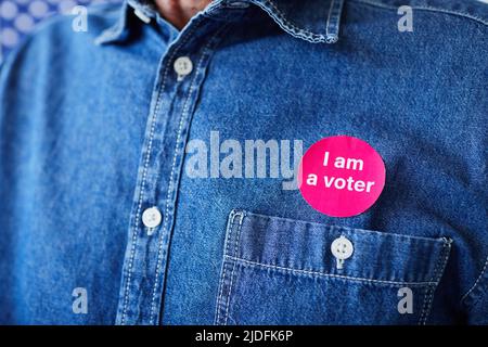 Close up of unrecognizable man with I am a voter sticker on shirt, copy space Stock Photo