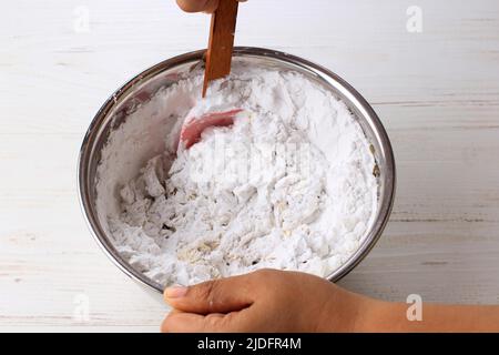 Process Cooking or Baking: Asian Female Hand Mix Tapioca Flour in the Stainless Bowl using Silicone Spatula Stock Photo