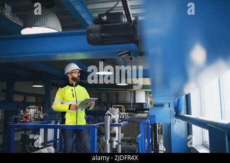 Portrait of engineer working in industrial factory Stock Photo