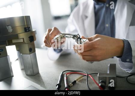 Close-up of engineer working in laboratory. Stock Photo