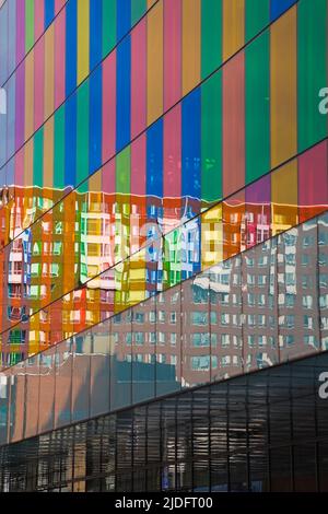 Building reflected in colored glass windows of the Palais des Congres, Old Montreal, Quebec, Canada. Stock Photo