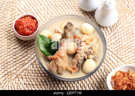 Top View Opor Ayam Putih or Chicken White Curry, Traditional Indonesian Food made from Chicken Cooked with Coconut Milk and Spices, Served to celebrat Stock Photo