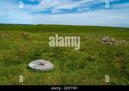 Limestone crushing stone in a crushing circle at Burning Drake lead mine, a Scheduled Monument, on Eldon Hill, Derbyshire. Stock Photo