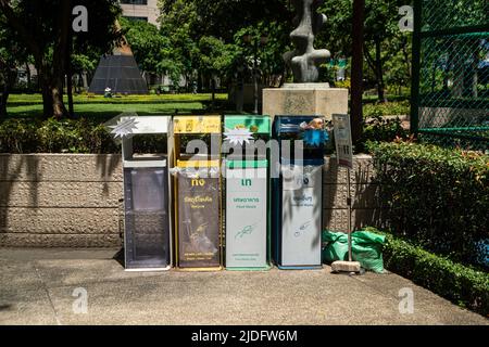 BANGKOK ,THAILAND - JUNE 9 , 2022 :  Garbage bins are arranged neatly and beautifully, easy to sort into different types. in Benjasiri public park. Stock Photo