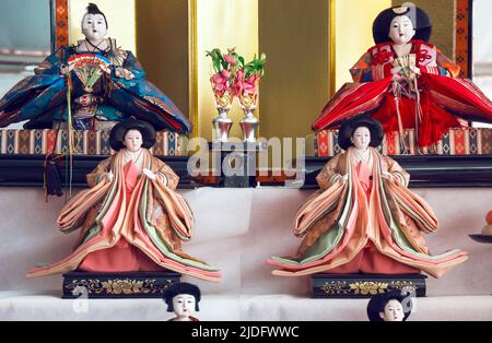 Traditional Japanese dolls with beautiful ornaments and colorful fabrics. Japanese dolls are an essential element of the nation's culture, there is ev Stock Photo