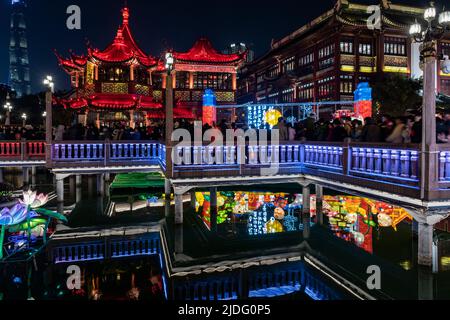 A crowd of tourists walk through the famous Nine-turning-bridge of Yu Yuan to view the spectacular displays during the Lantern Festival. Stock Photo