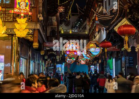 A crowd of tourist walk along the lanes in Yu Yuan, Yu Garden, to admire the display of lanterns during the lantern festival in the Year of the Pig. Stock Photo
