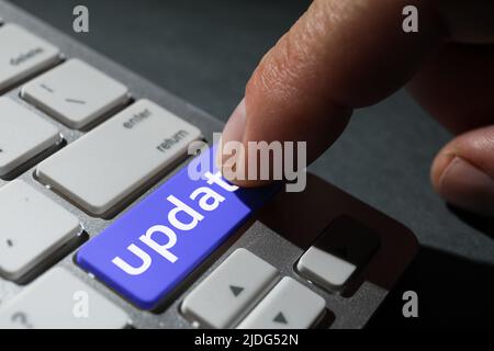 Man pressing button with word UPDATE on modern computer keyboard, closeup Stock Photo