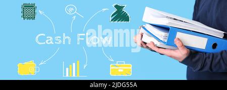 Man with folders and text CASH FLOW on light blue background Stock Photo