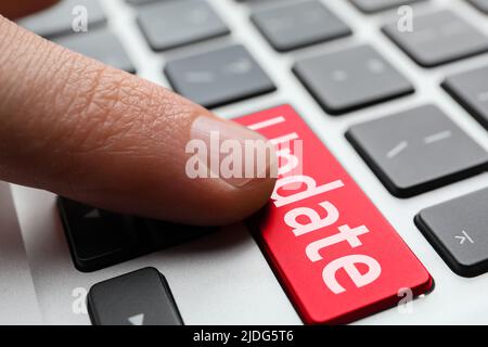 Man pressing button with word UPDATE on modern computer keyboard, closeup Stock Photo