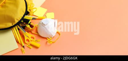 Different school supplies and medical mask on color background with space for text Stock Photo