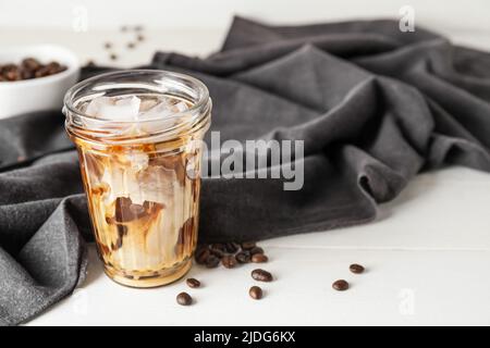 Glass with cold brew coffee on white wooden table Stock Photo