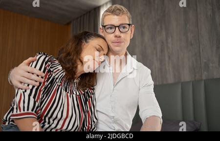 Husband consoles her tragic wife with depression in the bedroom, the wife and husband try to solve the difficult problems in life. Stock Photo