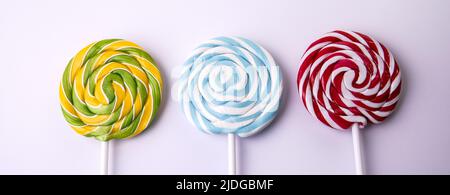 Three lollipops on a white background. Horizontal banner. Stock Photo