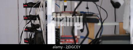 Rows of cryptocurrency mining equipment on farm Stock Photo