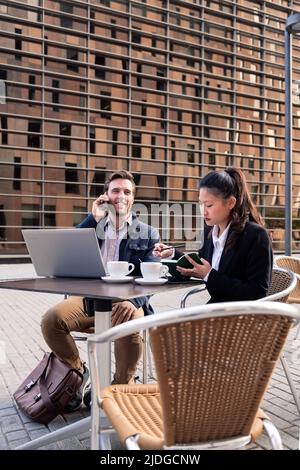 asian woman and caucasian man having work meeting Stock Photo