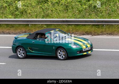 2002 green yellow MG TF custom 1796cc petrol 5 speed manual cabrio driving on the M6 Motorway, Manchester, UK Stock Photo