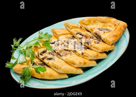 turkish pizza pide with cheese and meat on a black isolated background Stock Photo