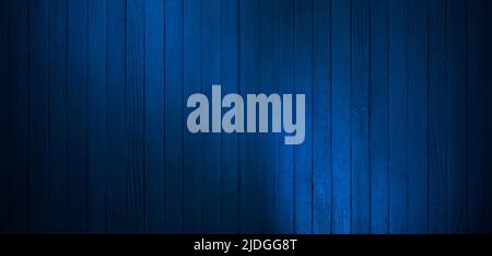 Spotlight reflected on dark blue old wall. The texture of the old wooden wall Stock Photo