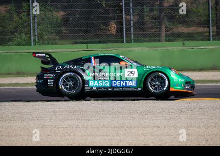 Porsche Carrera spectacular racing drive jumping on curbs on asphalt racetrack Stock Photo