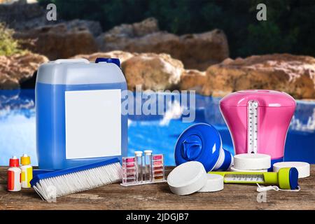 Equipment with chemical cleaning products and tools for the maintenance of the swimming pool. Stock Photo