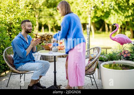 Young family having lunch at backyard on a summer afternoon Stock Photo