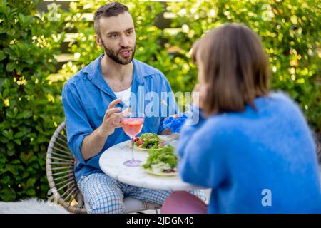 Stylish couple spend romantic evening at backyard Stock Photo