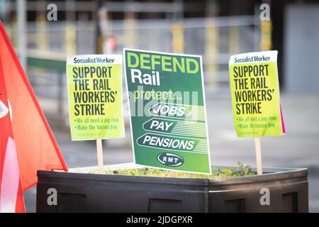 Manchester, UK. 21st June, 2022. RMT placards are left at Piccadilly train station. The biggest rail strike in over 30 years went ahead after last-minute talks failed. RMT states it has no choice but to strike due to proposed cuts to jobs, pay and pensions. Credit: Andy Barton/Alamy Live News Stock Photo